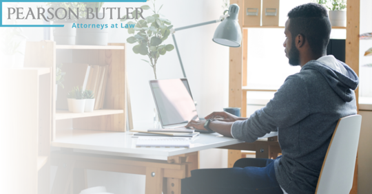 Man sitting at desk at home on laptop