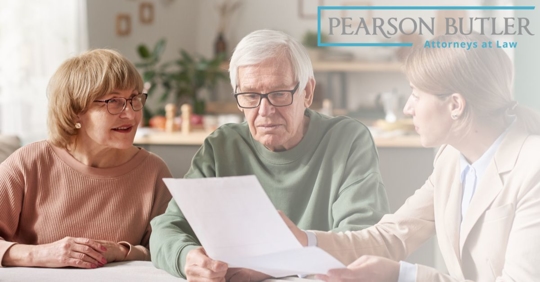A business woman reading off of a piece of paper to an elder couple