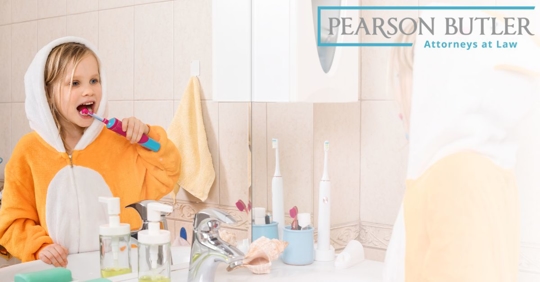 Picture of child in a onesie brushing their teeth