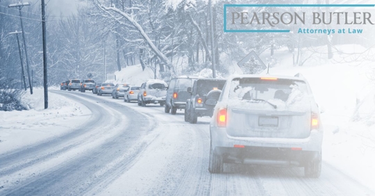 Cars lined up on road covered with snow.