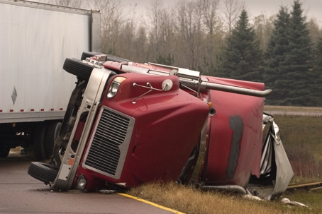 Red Semi tipped over from a crash
