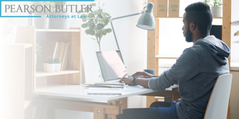 Man sitting at desk at home on laptop