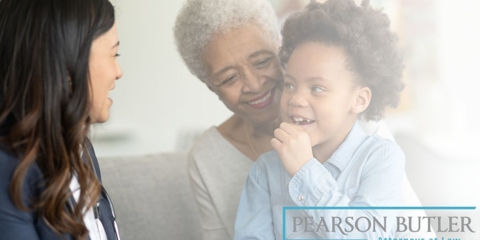 Grandmother and grandchild speaking with attorney
