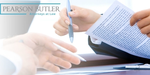 Person signing papers with pen