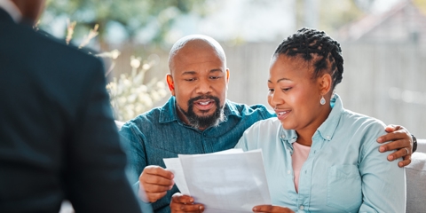 couple looking over documents with a lawyer