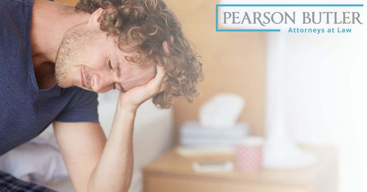 Man in pain holding his head.