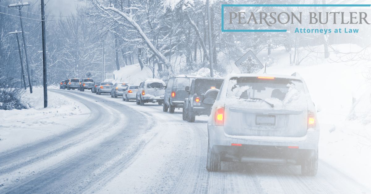 Cars lined up on road covered with snow.