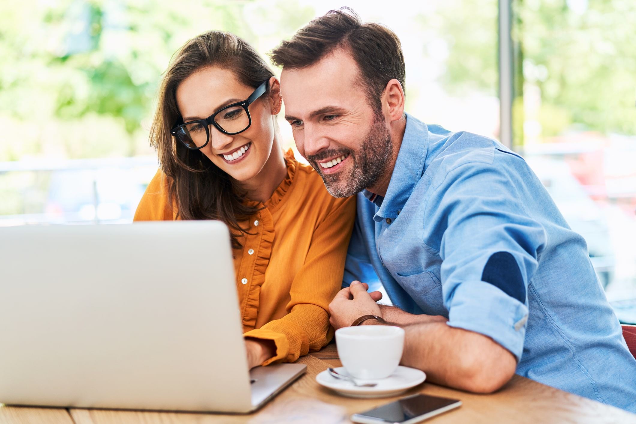 Happy couple looking at the computer