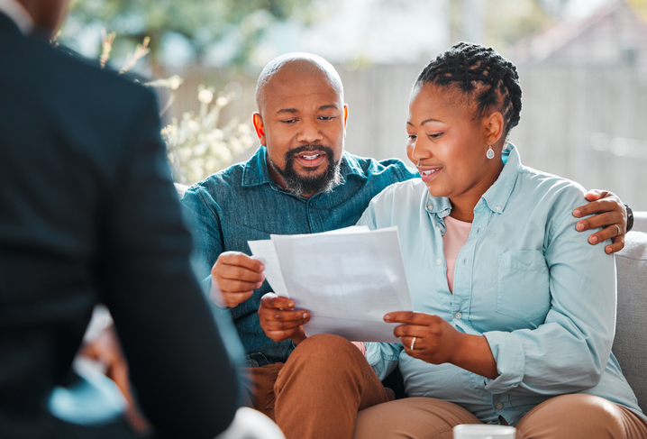 couple looking over documents with a lawyer