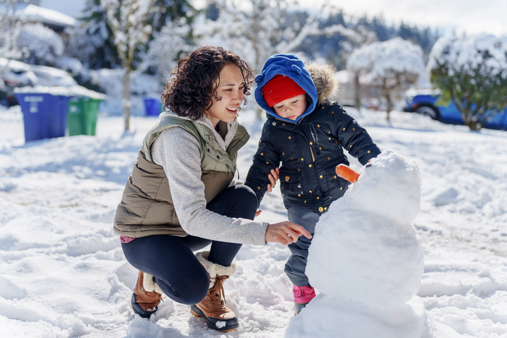mother and child playing in the snow